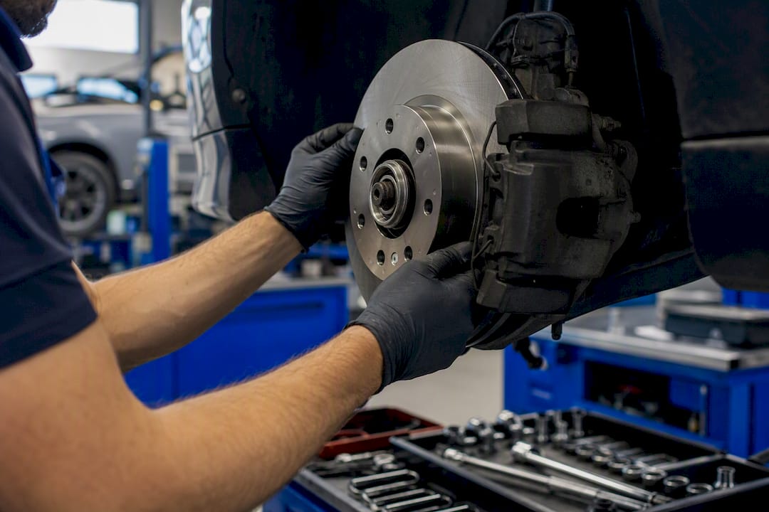 Mechanic installing brake components on rotor