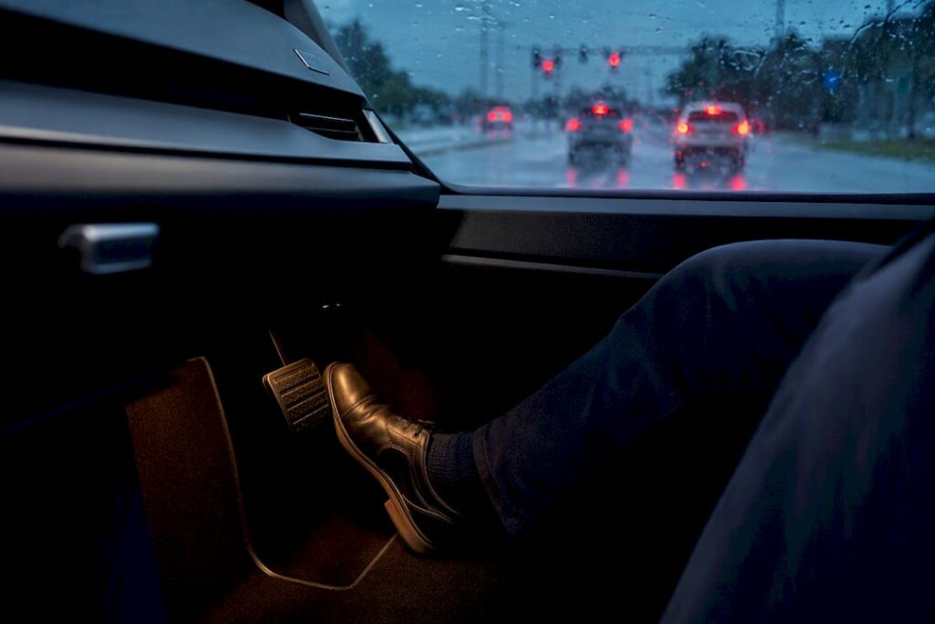 Driver braking on a rain-soaked road