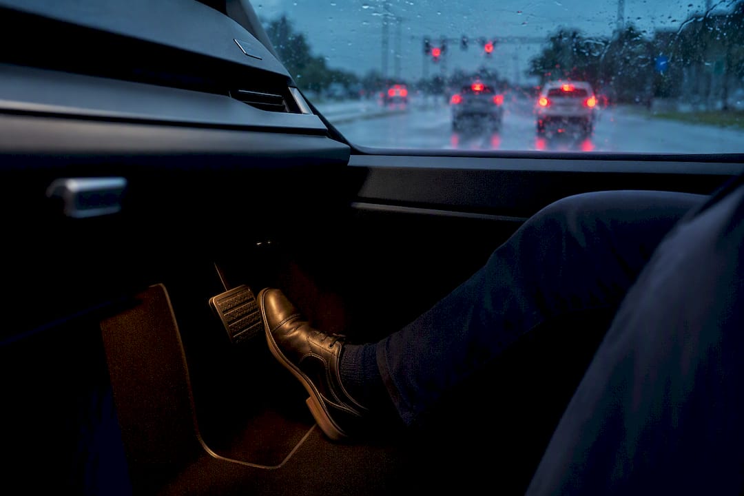 Driver braking on a rain-soaked road
