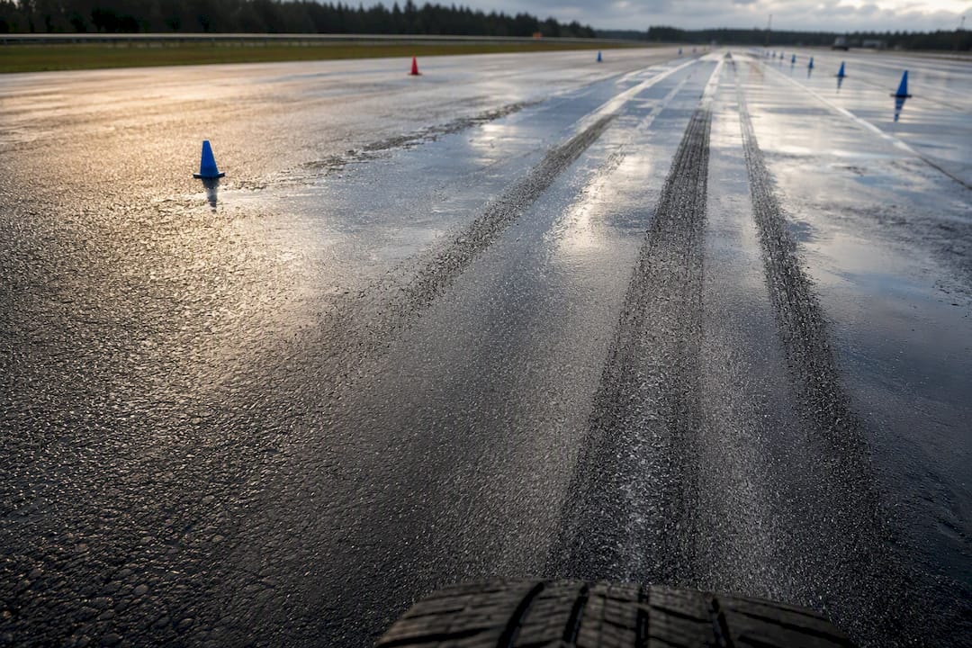 Wet road with extended braking tire tracks