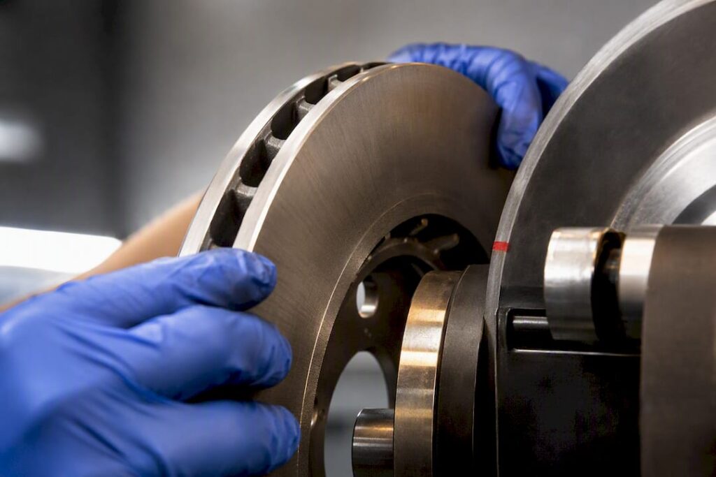 Technician inspecting anonymous brake rotor fitment